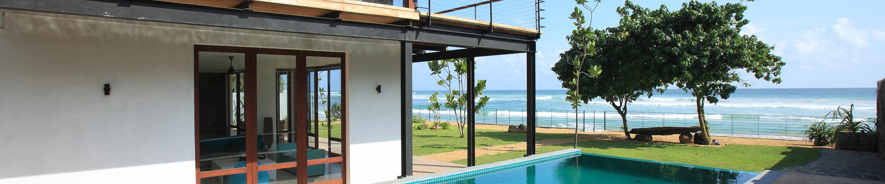 Sea view from the pool and a shady seat under a big tree