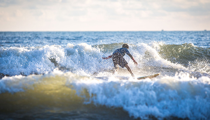 A child attempting to surf in the ocean