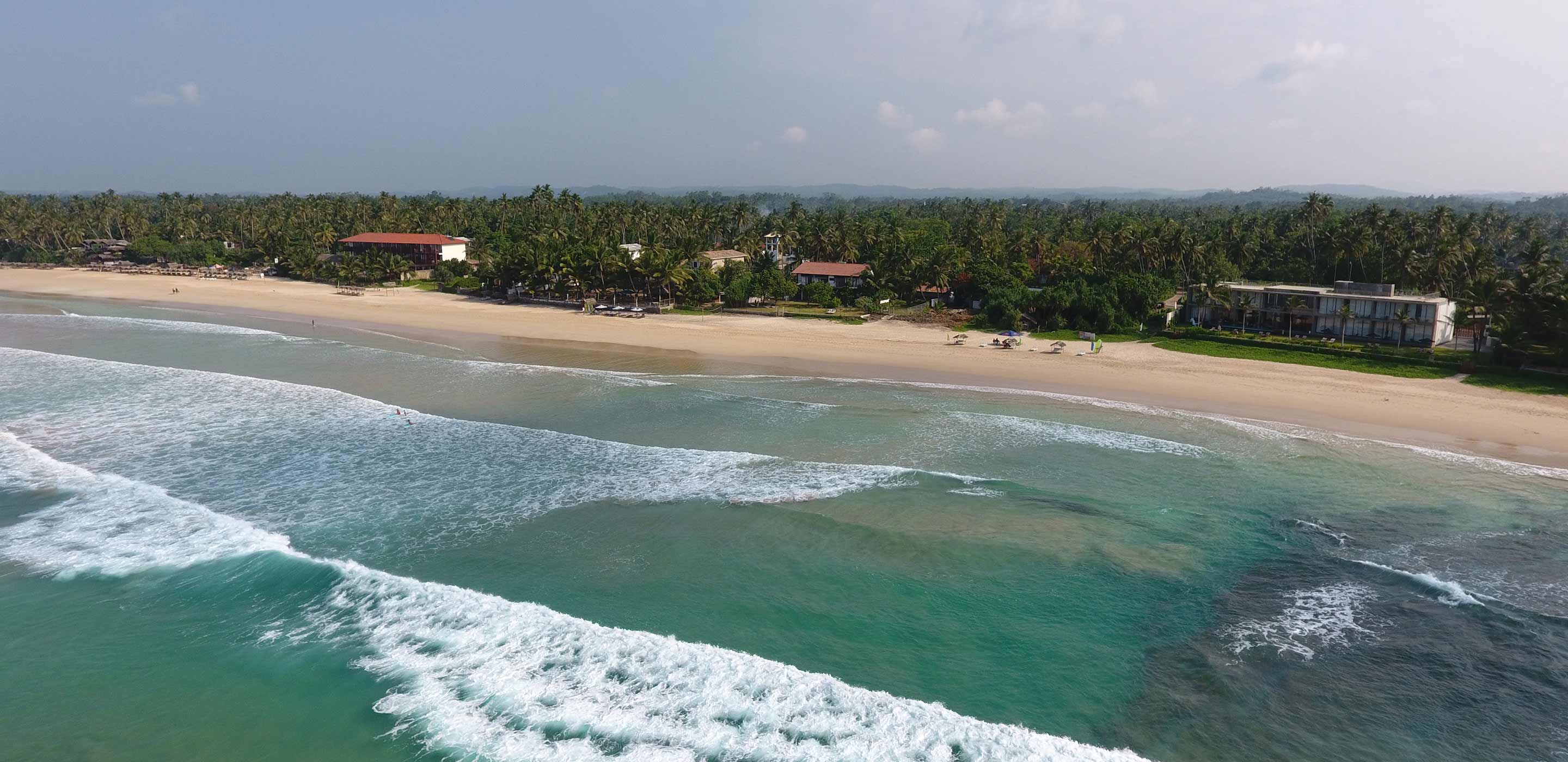 Aerial view of the property accompanied by sandy beaches in summer holidays