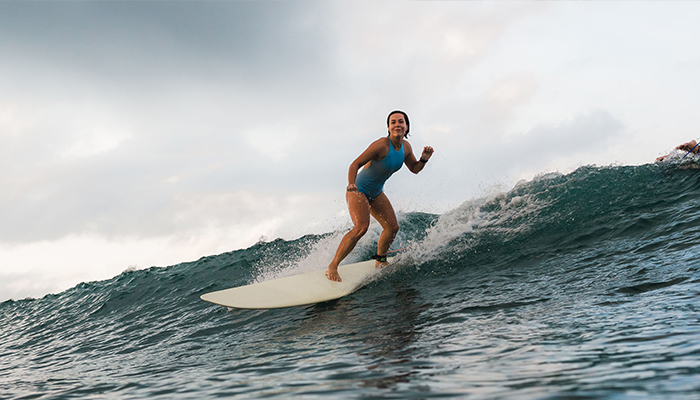 Female professional surfer tackling a big wave