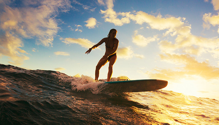 Female surfer beginning to surf