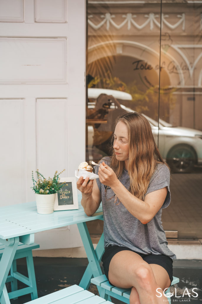 Young woman enjoying gelato outside the Isle of Gelato shop in Galle Fort, Sri Lanka