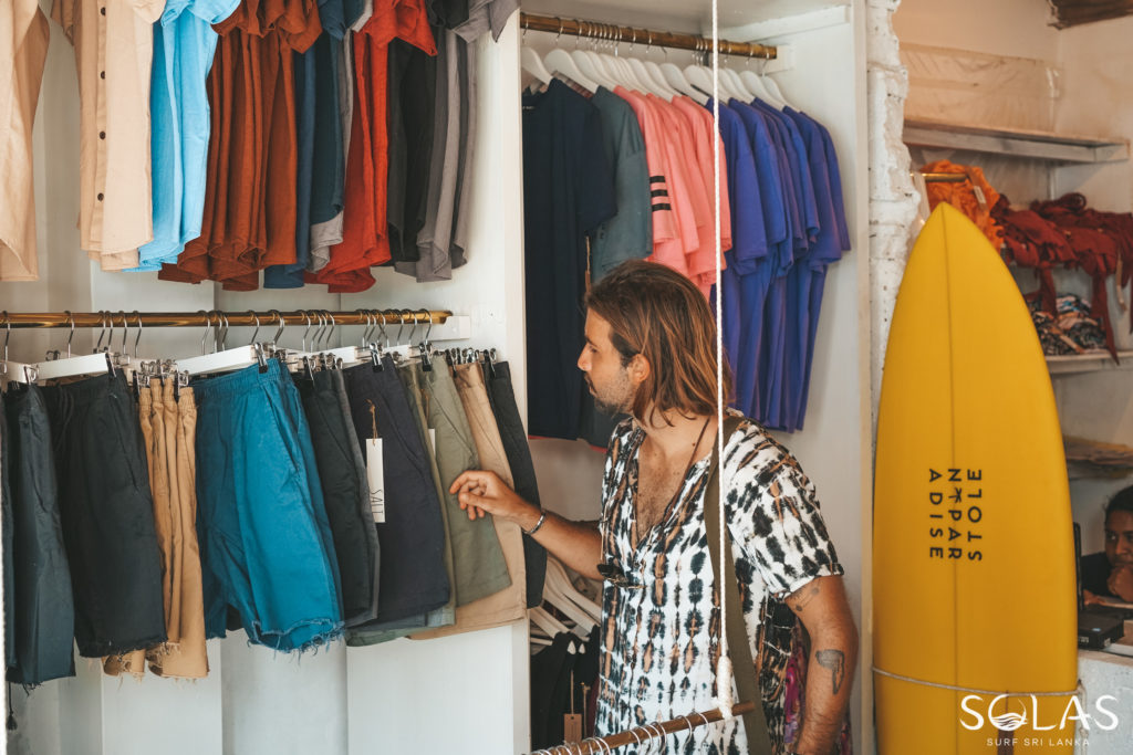 Young man shopping at the Stolen Paradise Store in Galle Fort, Sri Lanka