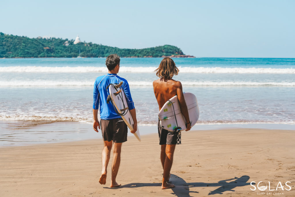 Surfers walking towards Ahangama Beach, Sri Lanka