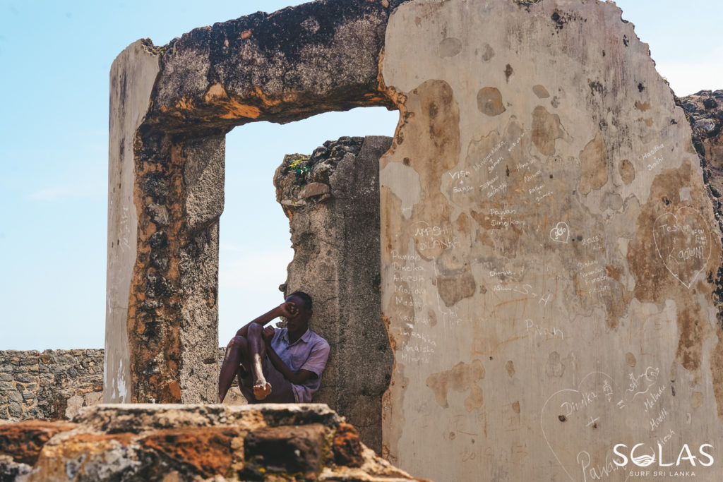 Local Sri Lankan man resting inbetween the ruins in Galle Fort, Sri Lanka